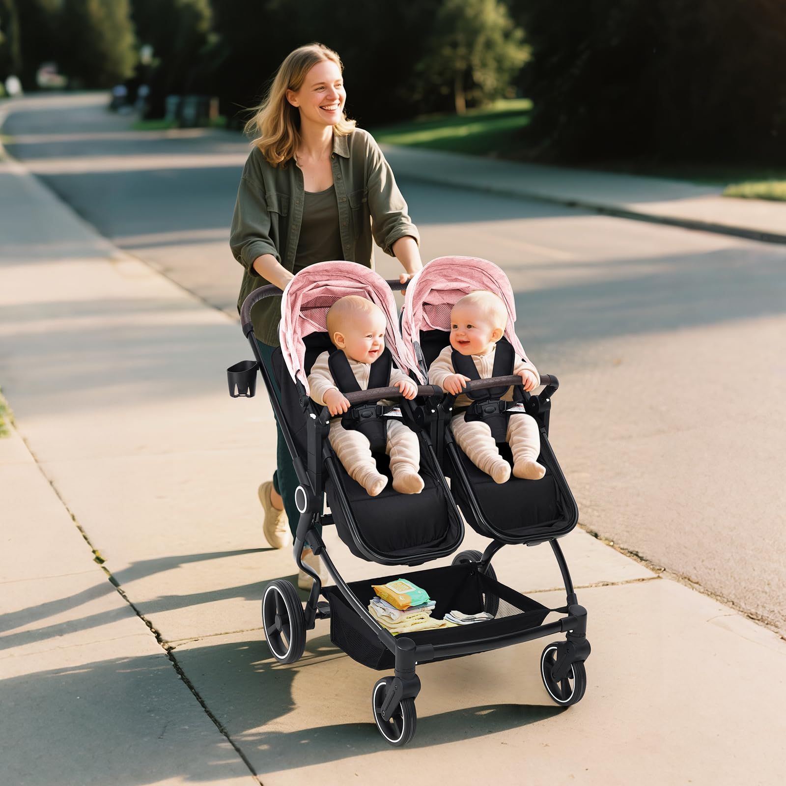 Pink tandem double stroller for newborn and toddler with adjustable recline, canopy, lightweight fold, and parent cup holders.